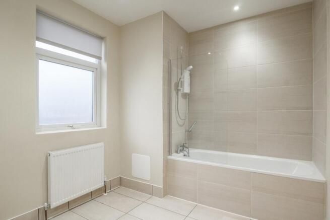 Property photo 2 of 10 Bright, Modern Bathroom With A Full Bathtub And Ov...