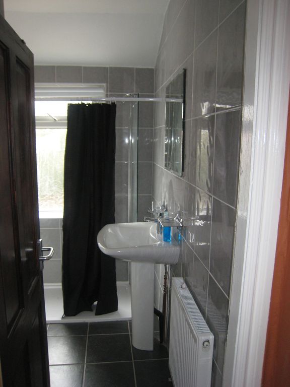 Property photo 3 of 15 This Stylish Bathroom Features Contemporary Fixtur...