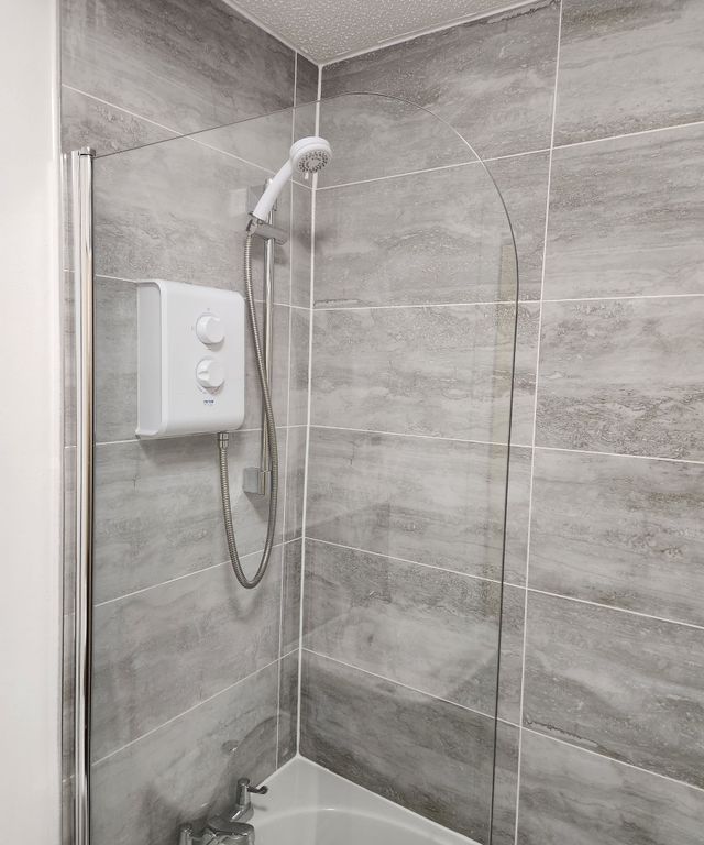 Property photo 3 of 4 Modern Electric Shower With Sleek Grey Tiling...
