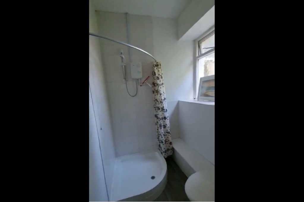 Property photo 3 of 7 Bright Bathroom Featuring A Corner Shower With A P...