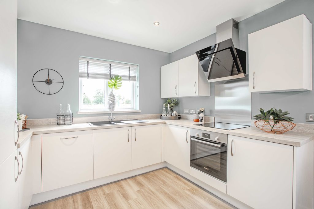 Property photo 1 of 6 A Modern White Kitchen With A Light Wood Floor In The Foreground And A Light Gray Wall With A Window