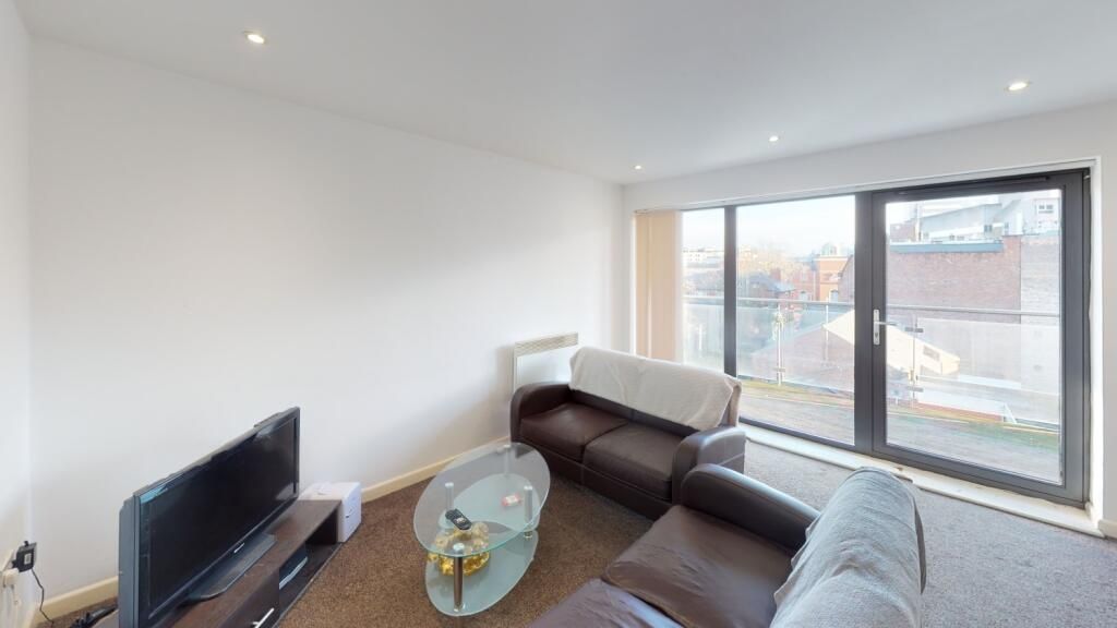 Property photo 1 of 5 Bright And Modern Living Room Featuring A Comforta...