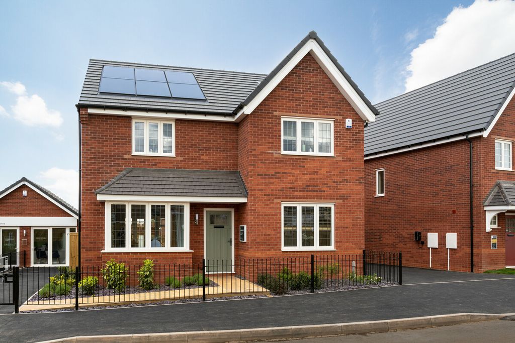 Property photo 1 of 10 A Modern Red Brick House With Solar Panels On The Roof Stands In The Foreground