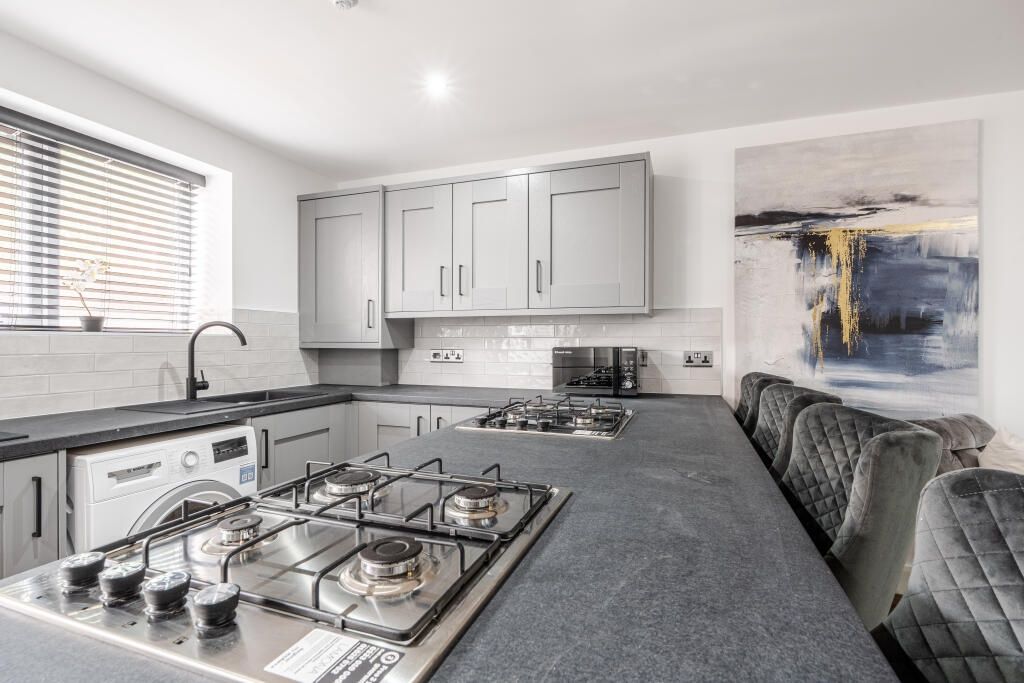 Property photo 1 of 12 Modern And Well-Maintained Kitchen Featuring Sleek...