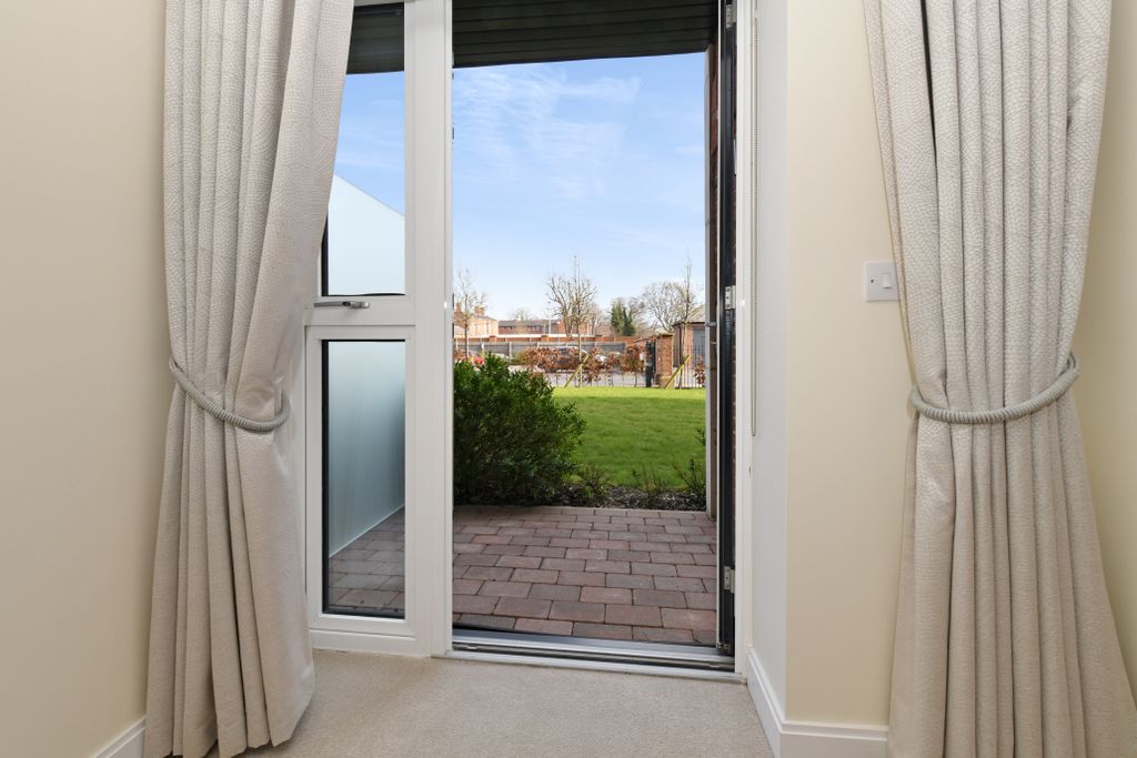 Property photo 3 of 17 A Doorway With A View Of A Grass Field And Buildings