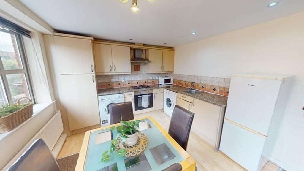 Property photo 2 of 6 Bright And Tidy Kitchen Featuring Ample Natural li...