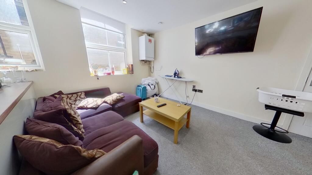 Property photo 2 of 14 Bright And Cozy Living Room Featuring A Comfortabl...