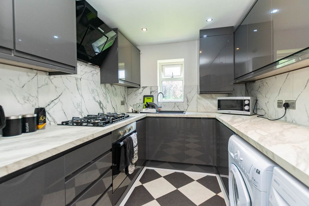 Property photo 2 of 5 Modern And Sleek Kitchen With Glossy Grey Cabinets...