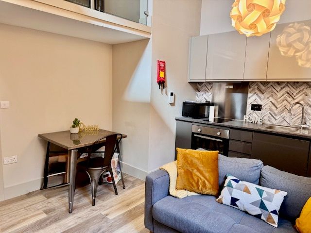 Property photo 2 of 8 Bright, Modern Open-Plan Living Area With A Cozy S...