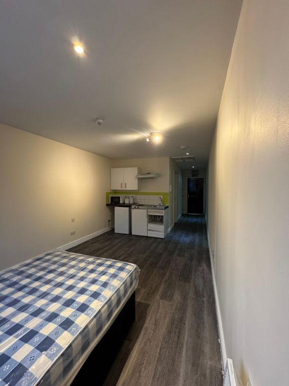 Property photo 2 of 2 A Spacious Living Area Featuring A Comfortable Sle...