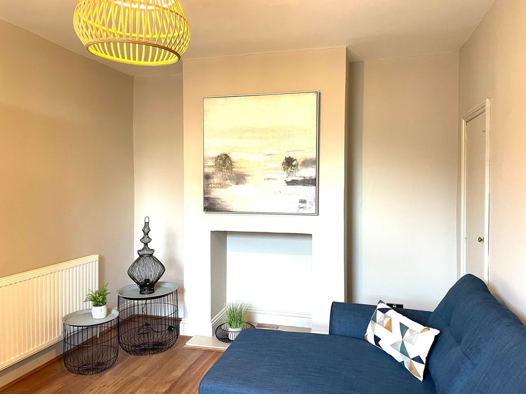 Property photo 3 of 10 A Bright And Stylish Living Room Featuring A Moder...