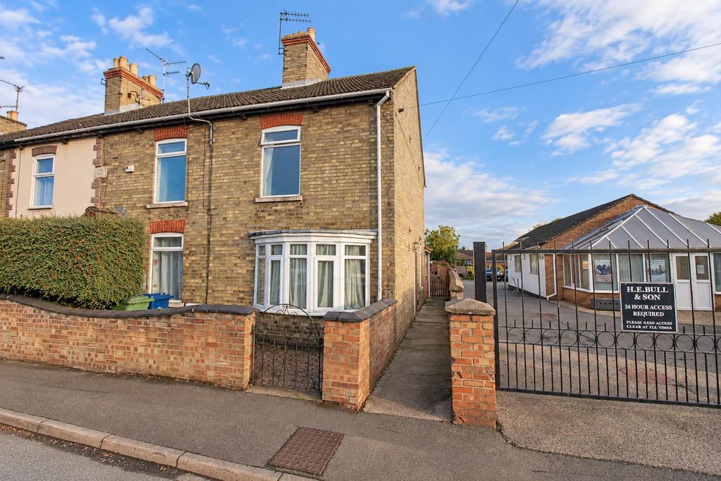 Property photo 1 of 12 British Corner House With Wrought-Iron Gates.Png