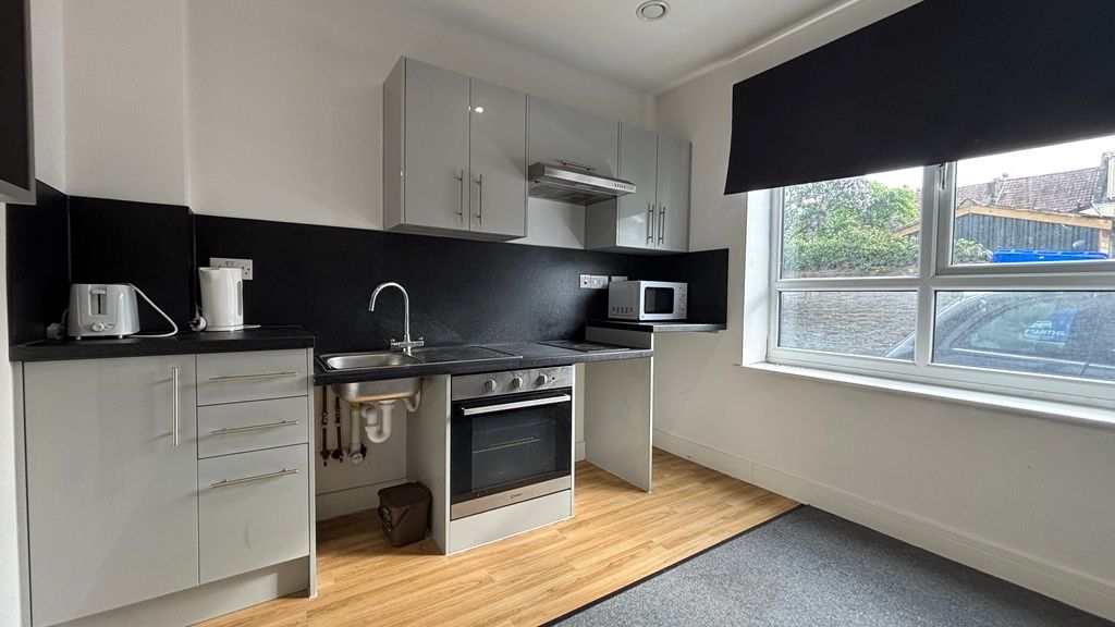 Property photo 1 of 7 Modern Kitchen With Sleek Grey Units And Window...