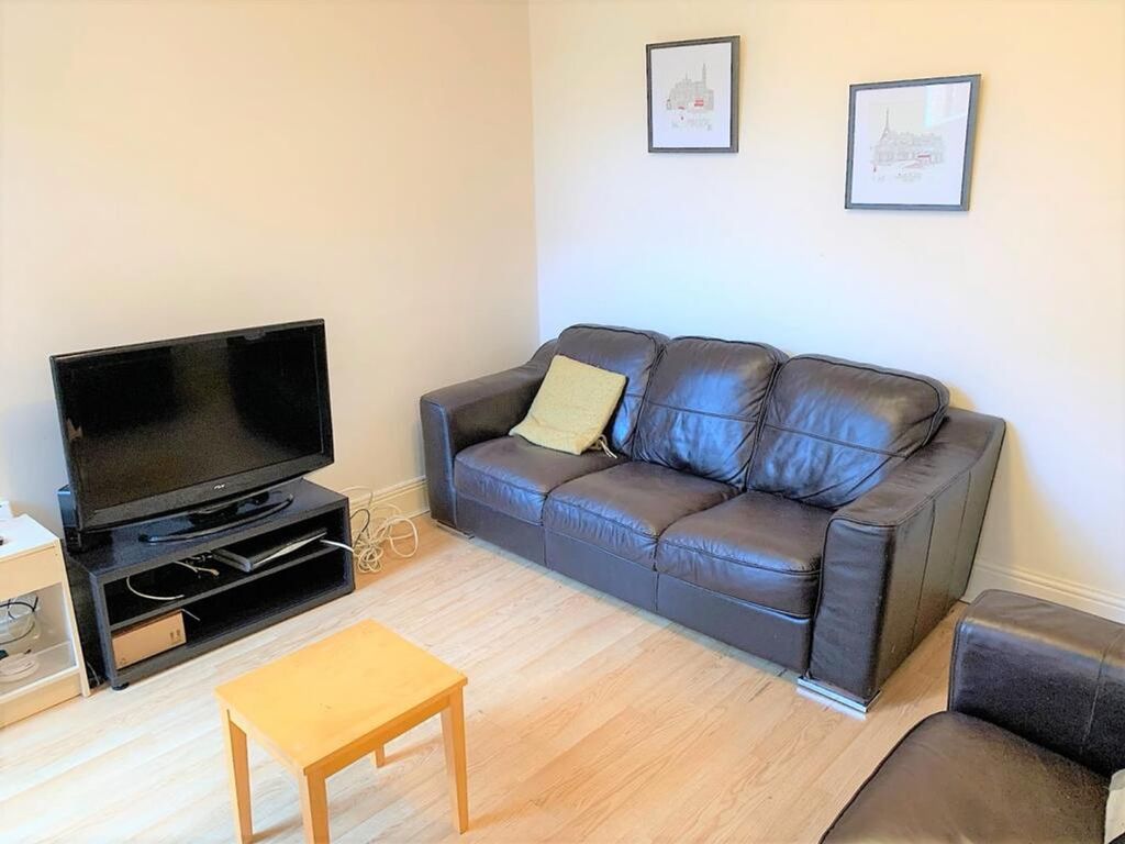 Property photo 3 of 12 A Cozy Living Room Featuring A Comfortable Leather...