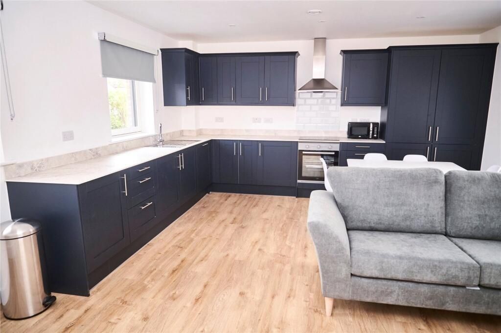 Property photo 3 of 12 Bright And Modern Kitchen Featuring Sleek Black Ca...