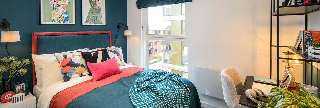 Property photo 3 of 5 Brightly Decorated Bed With Wall Hangings Above, Opposite A Desk With Shelving Unit Above