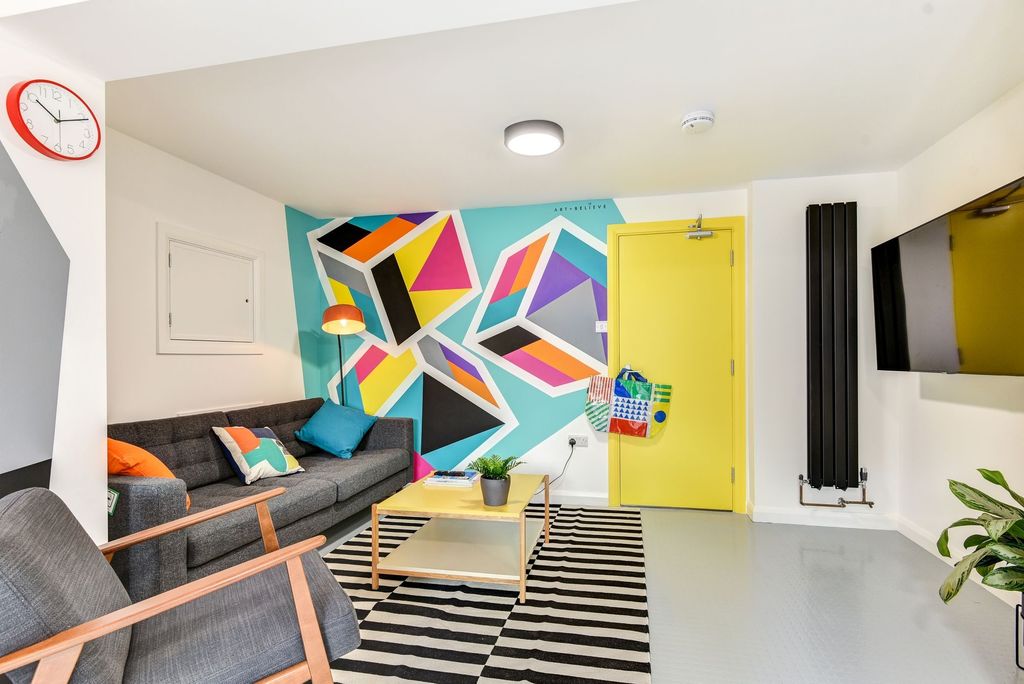 Property photo 2 of 6 A Vibrant And Modern Living Room Featuring A Styli...