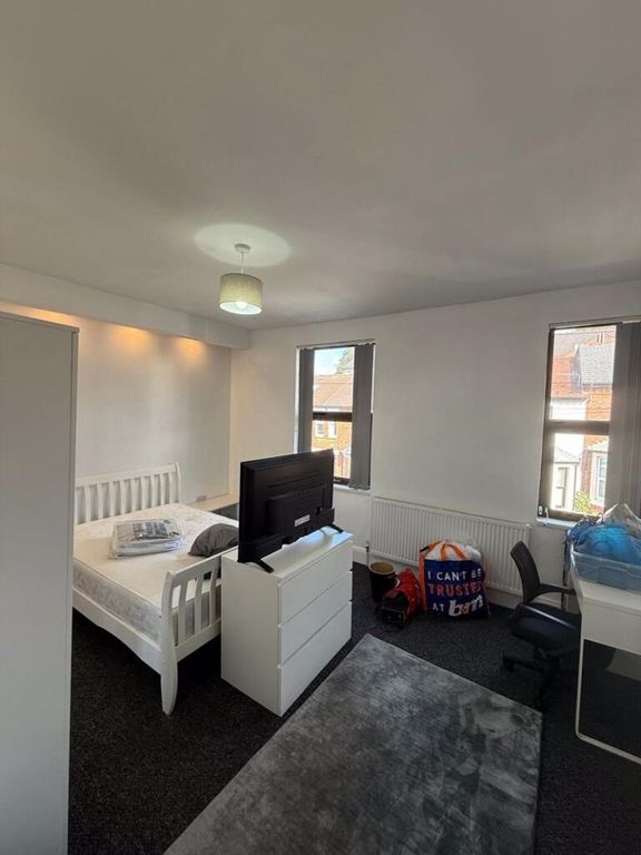 Property photo 2 of 10 A Bright And Cozy Living Room Featuring Large Wind...