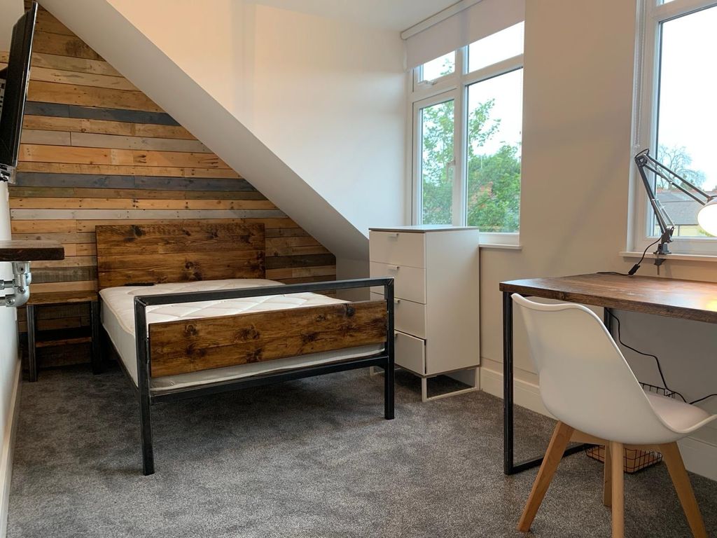 Property photo 3 of 7 A Modern Bedroom Featuring A Wooden Headboard And ...