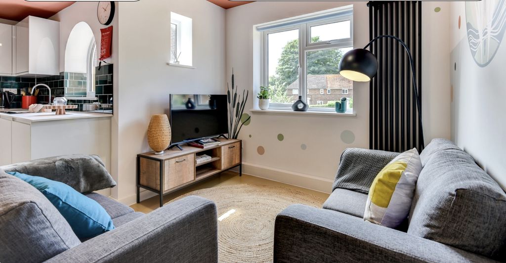 Property photo 2 of 5 Bright And Inviting Living Room Featuring Modern d...