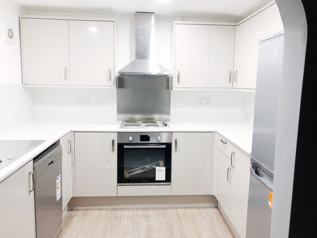 Property photo 1 of 19 Bright Modern Galley-Style Kitchen With White Cabi...