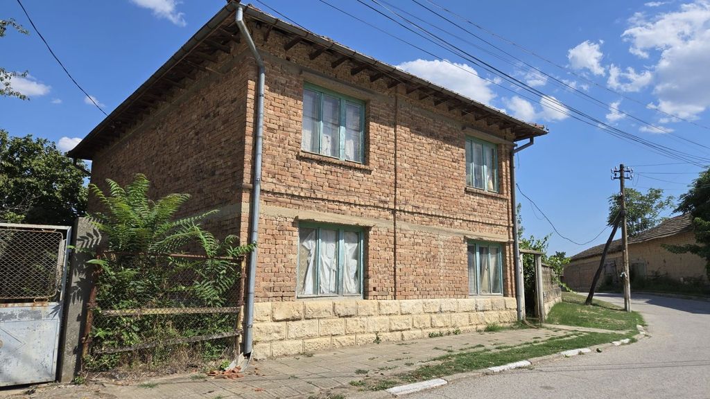 Property photo 3 of 56 Corner Perspective Of A Brick House Showing Green Window Frames And A Metal Gate Entrance