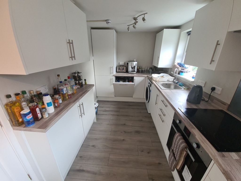 Property photo 1 of 18 Bright And Modern Kitchen Featuring Sleek White Ca...