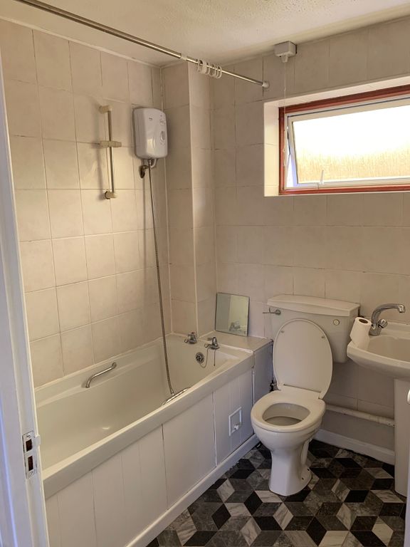 Property photo 2 of 5 A Clean And Well-Lit Bathroom Featuring A Bath, Pe...