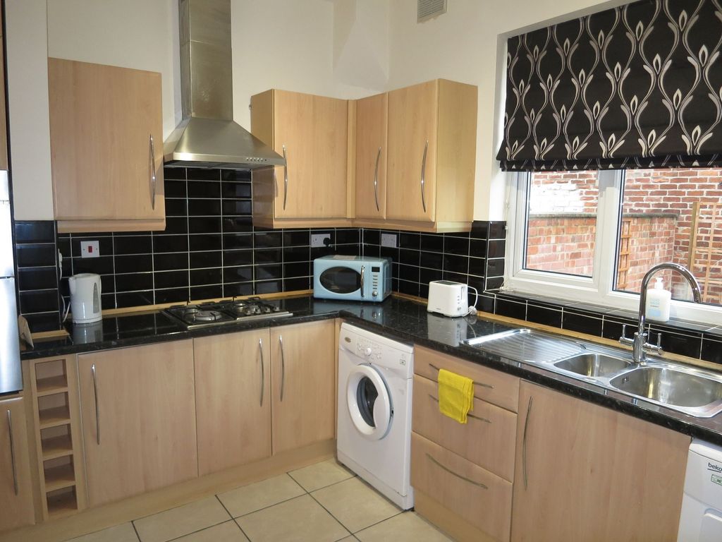 Property photo 3 of 22 A Modern Kitchen Featuring Wooden Cabinetry, Black...