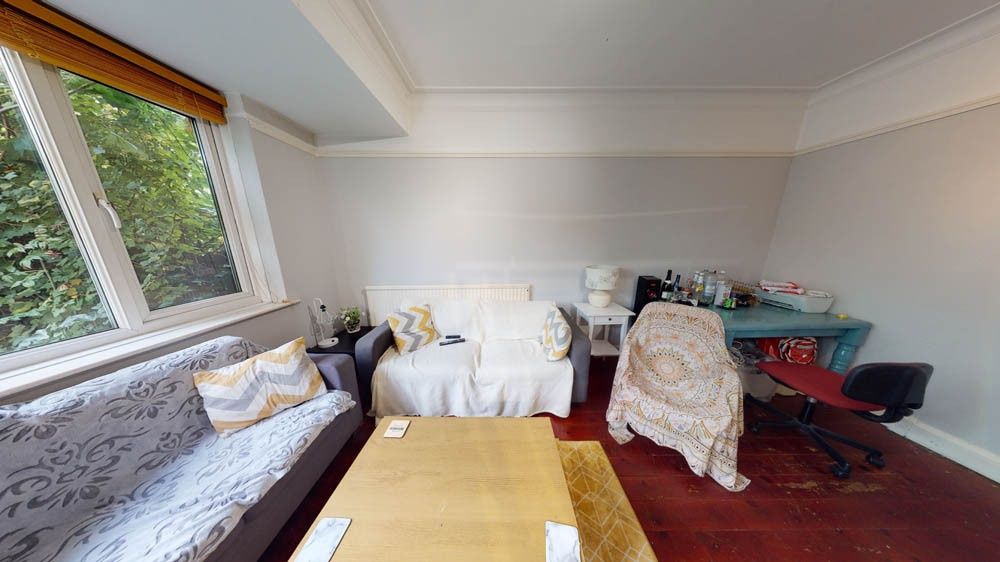 Property photo 3 of 7 A Spacious, Well-Lit Living Room Featuring Comfort...