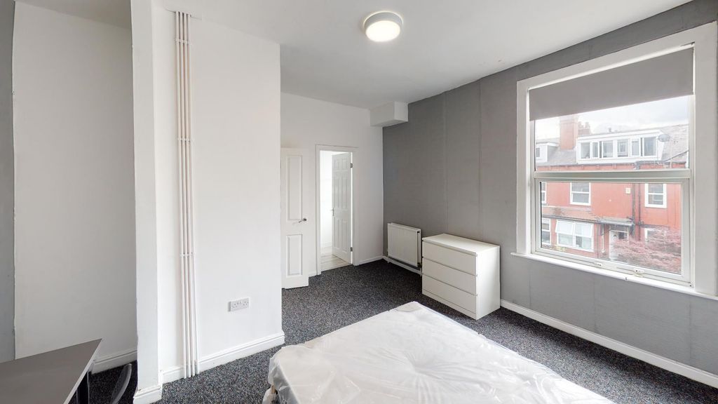 Property photo 2 of 26 Bright And Modern Living Room Featuring Large Wind...