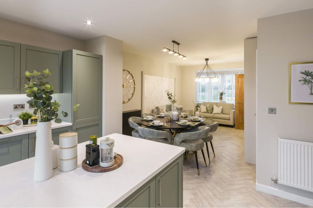Property photo 1 of 10 A Modern Kitchen Island With Decorative Items In The Foreground Leads To A Dining Area With A Round