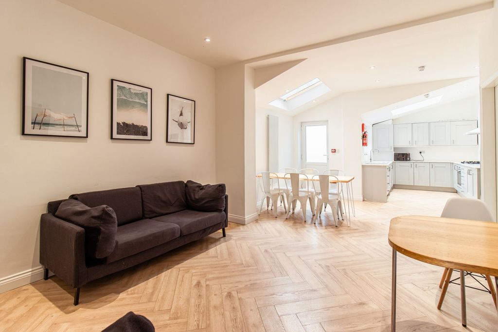 Property photo 1 of 10 A Bright And Spacious Living Area Featuring A Comf...