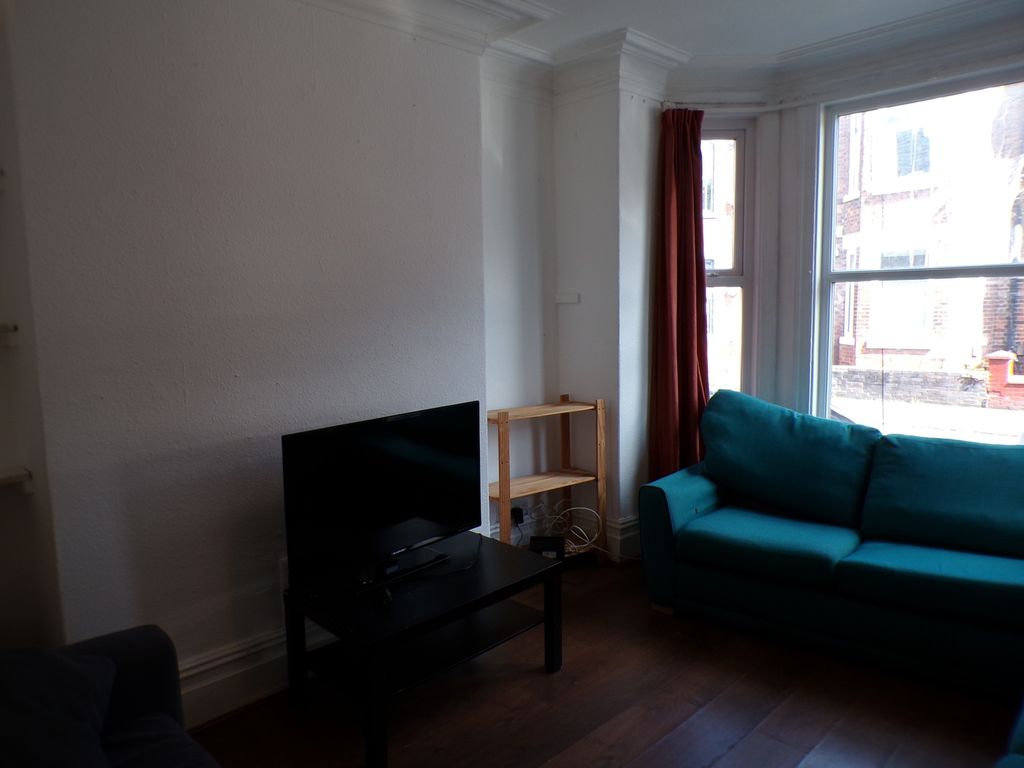 Property photo 3 of 9 A Bright And Inviting Living Room Featuring A Cozy...