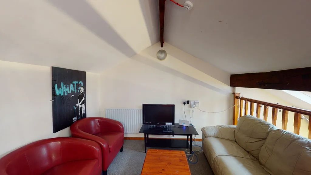 Property photo 3 of 13 A Cozy And Inviting Living Room Featuring Comforta...