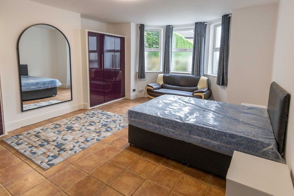 Property photo 2 of 5 Bright And Welcoming Living Room Featuring Large W...