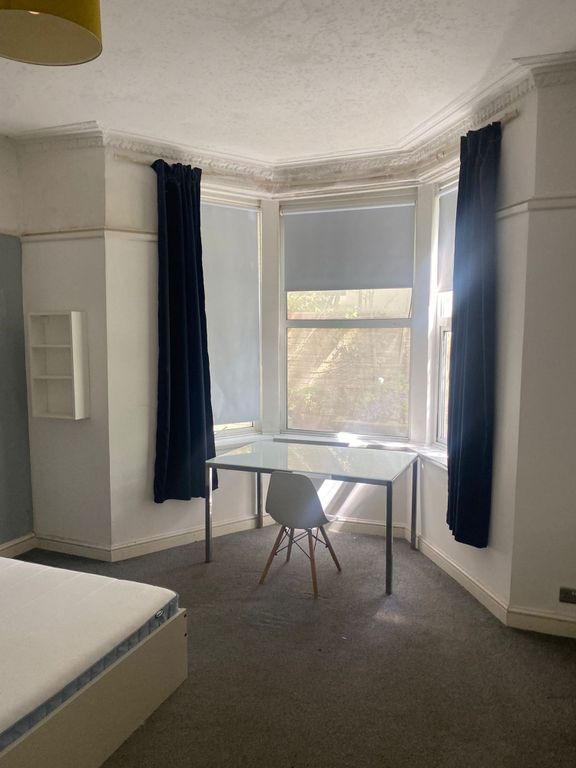 Property photo 3 of 8 A Bright And Airy Bedroom Featuring A Large Bay Wi...