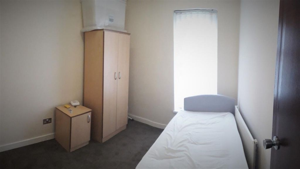 Property photo 3 of 5 A Modest Single Bedroom Featuring A Neatly Made Be...