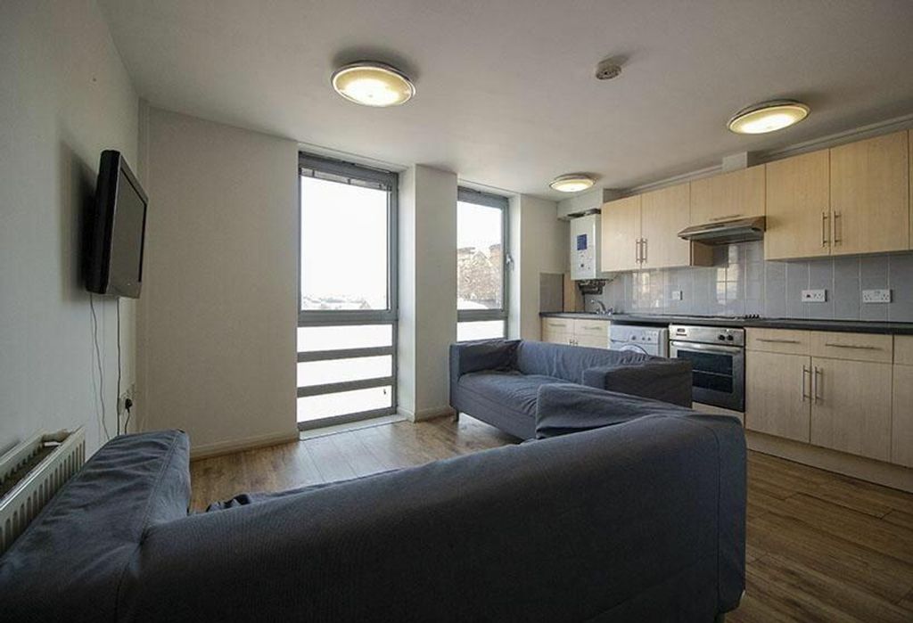 Property photo 1 of 4 A Bright And Inviting Living Room Featuring Modern...