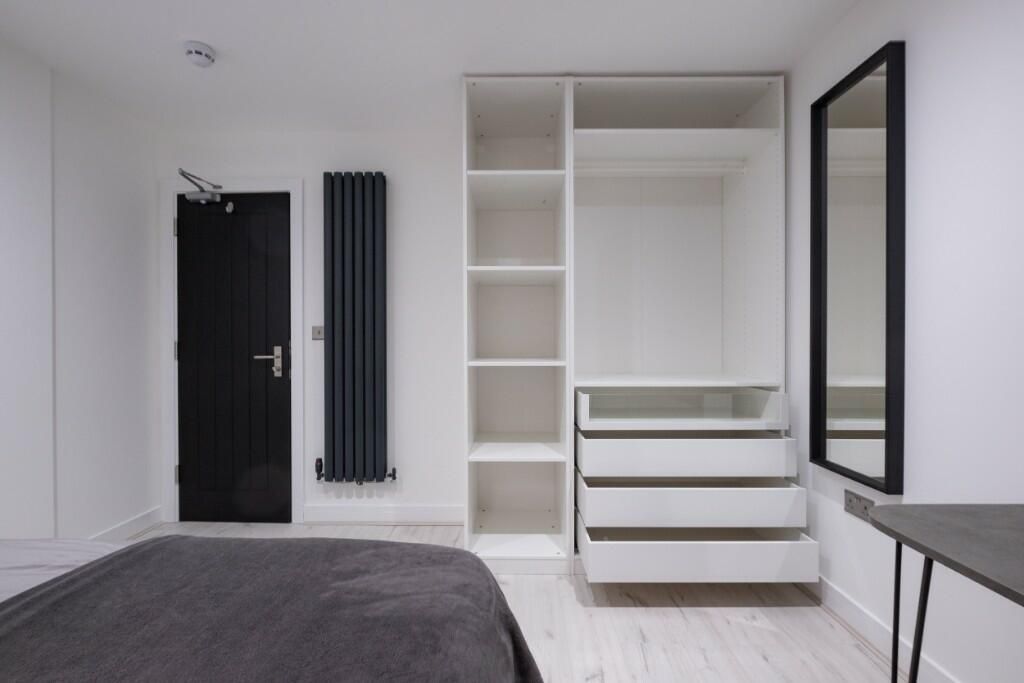 Property photo 3 of 15 A Modern And Tidy Master Bedroom Featuring A Spaci...