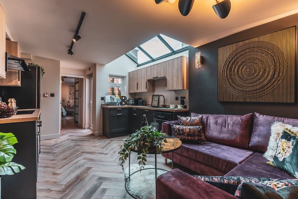 Property photo 1 of 9 Stylish Open-Plan Living Area With A Plush Purple ...