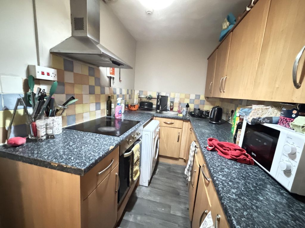 Property photo 3 of 15 A Well-Equipped Kitchen Featuring Wooden Cabinets,...