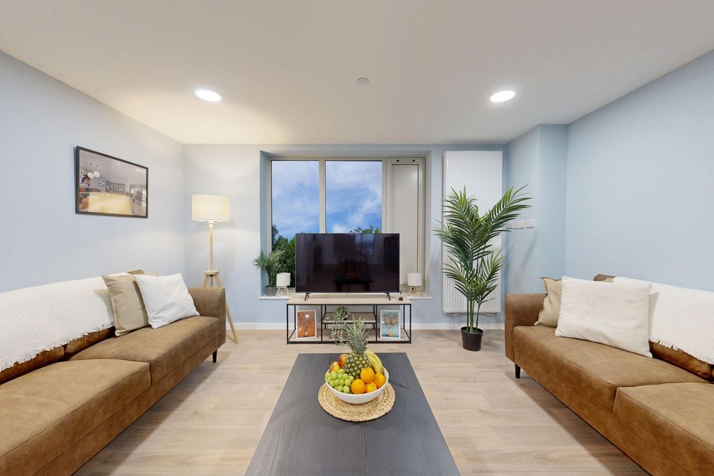 Property photo 3 of 15 A Bright And Inviting Living Room Featuring Modern...