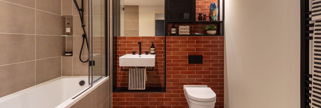 Property photo 3 of 3 Shower Over Bath, Wash Basin With Mirror, Heated Towel Rack, Shelving, Red Brick Style Tiles.