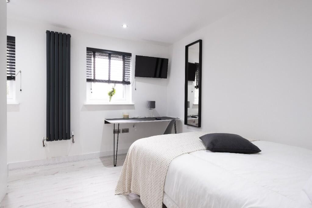 Property photo 3 of 11 A Bright And Minimalist Bedroom Featuring A Comfor...
