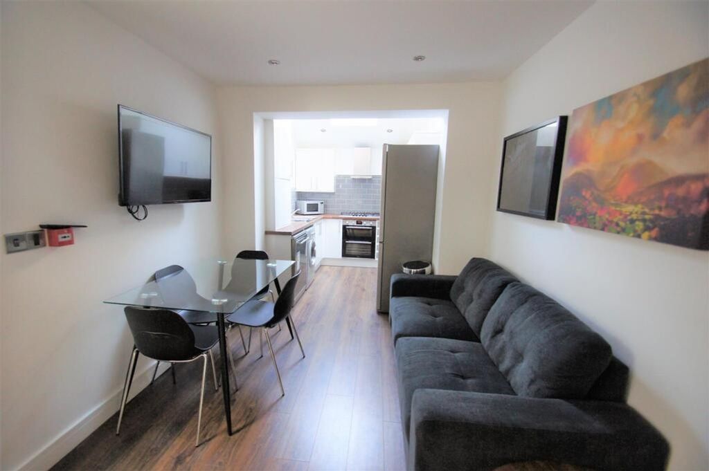Property photo 2 of 8 A Modern And Inviting Living Room Featuring A Comf...