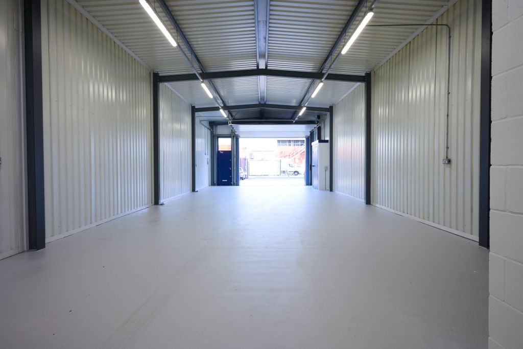 Property photo 3 of 4 The Interior Of A Warehouse Unit, Facing The Front Electric Roller Shutter, Which Is Open And Large Enough For Vehicle Access.
