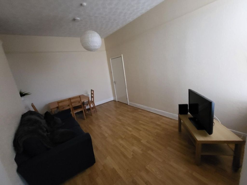 Property photo 2 of 7 A Bright Living Room Featuring Wooden Flooring, A ...