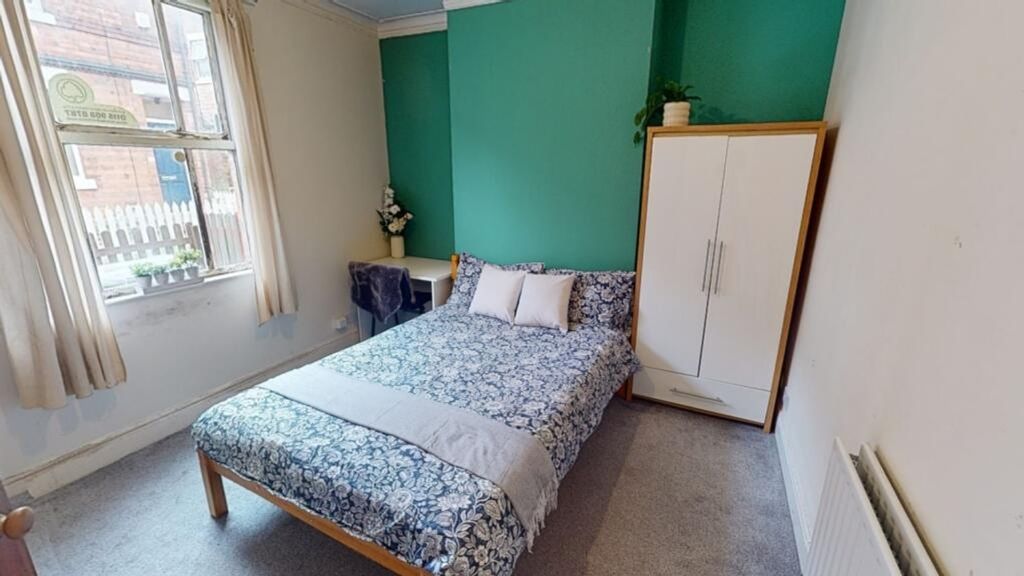 Property photo 3 of 8 This Inviting Double Bedroom Features A Cozy Bed W...