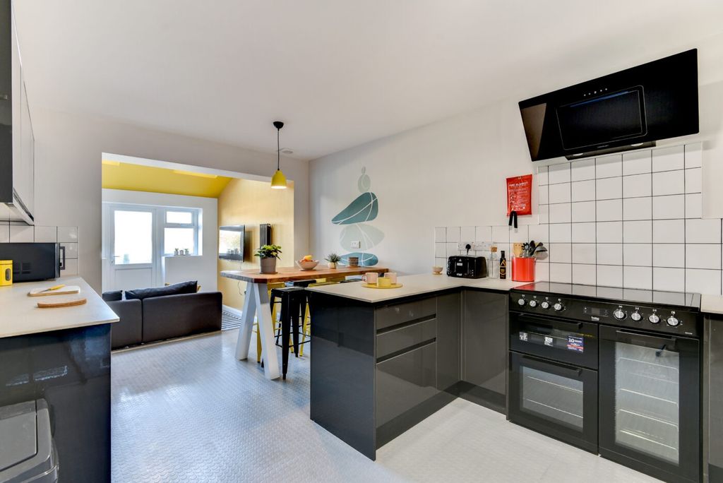 Property photo 2 of 6 Bright Modern Kitchen With Glossy Dark Cabinets, A...